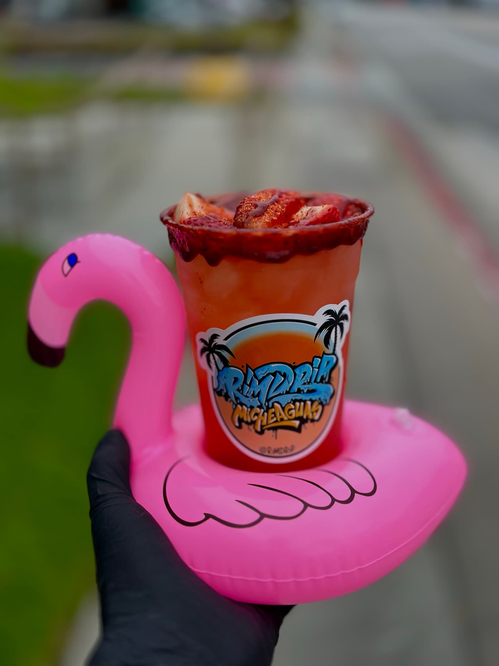 Strawberry michelada served on a flamingo pool float — Rimdrip festivities
